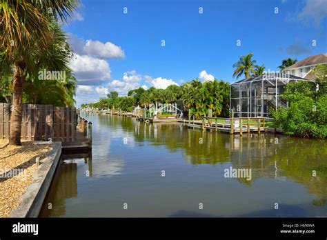 Waterfront homes with boats on canal in Fort Myers beach, Florida Stock ...