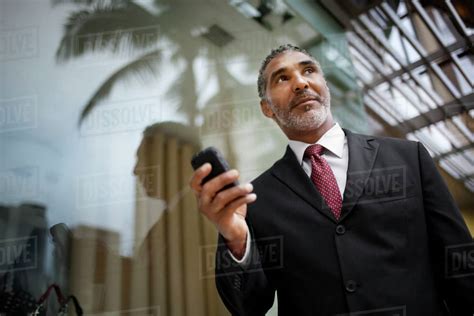 Businessman Sending A Text Message On A Cell Phone Stock Photo