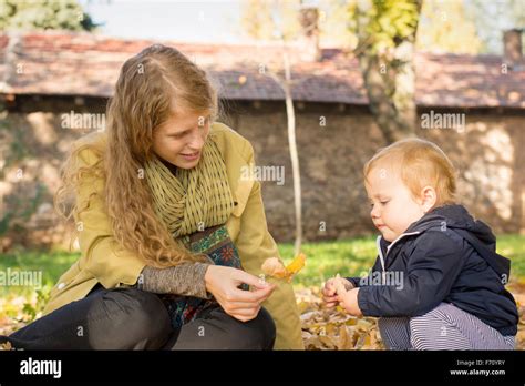 Blonde Mom Plays With Her Sweet One Year Old Daughter In The Park Stock Photo Alamy