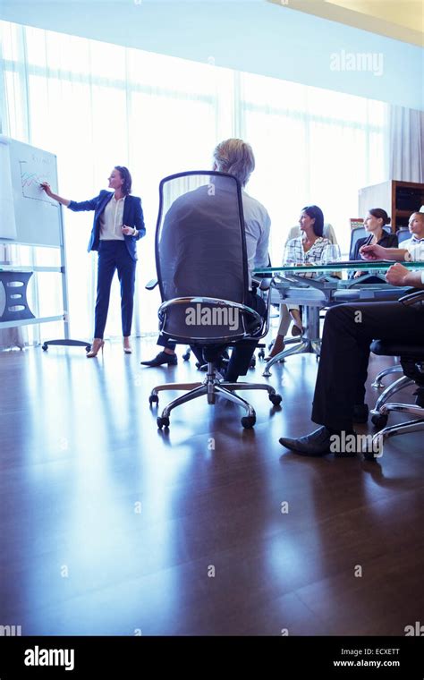 Businesswoman Giving Presentation In Conference Room Stock Photo Alamy