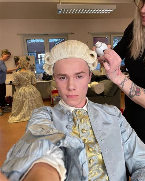 A Man Is Getting His Hair Done In A Salon While Another Woman Watches