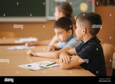 Schoolboy rise hand in classroom. Elementary school. Education Stock ...