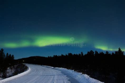 Aurora Borealis, Northern Lights Over a Frozen Road in Ivalo in Finland ...