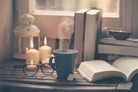 Still Life Of Used Books Tea Time Glasses And Candles On A Wood