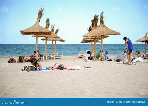 People Enjoy The Sun And Sand On A Beach From The Black Sea Resort Of