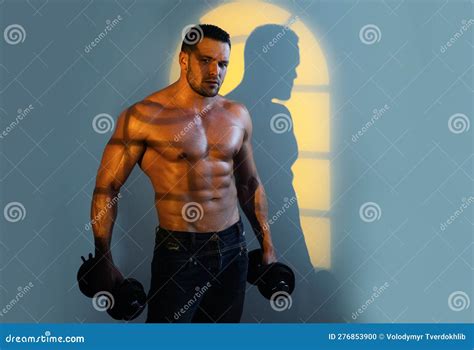 Powerful Bodybuilder Doing The Exercises With Dumbbells Strong Male With Naked Torso On Night
