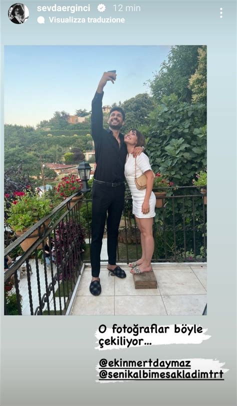 The Man And Woman Are Taking A Selfie In Front Of Their Balcony Railings