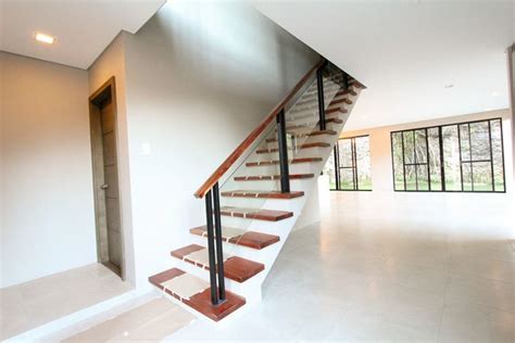 An Empty Room With Some Stairs And Windows