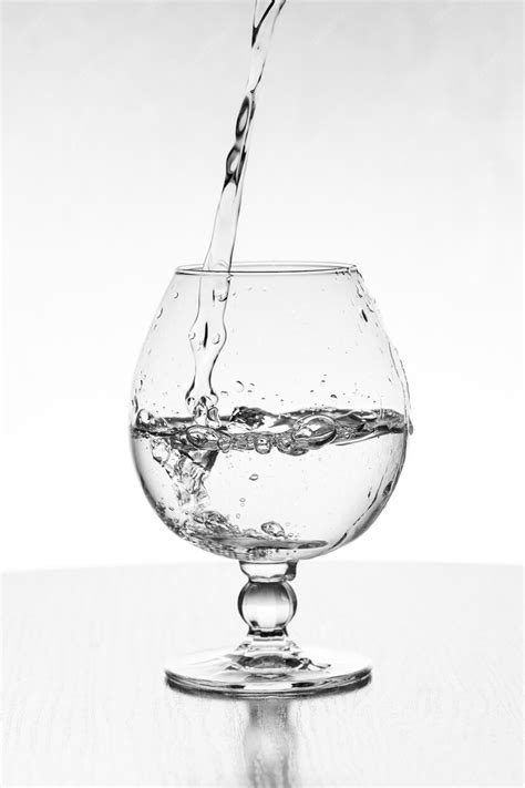 Premium Photo Pouring Water Into A Glass Isolated On White Background