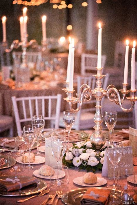 The Table Is Set With Candles And Place Settings For An Elegant Dinner