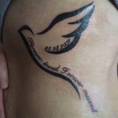 Memorial tattoo of a bird including a date and the