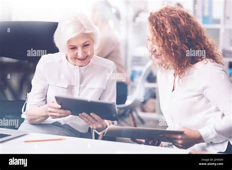 Attentive Blonde Bowing Her Head Before The Tablet Stock Photo Alamy