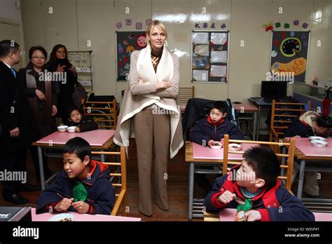 Princess Charlene Wittstock of Monaco poses amongst young students