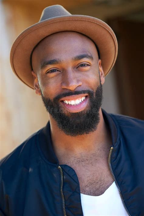 Portrait Of Smiling African American Man Wearing Hat In Garden At Home