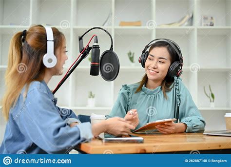 Happy Asian Female Radio Guest Enjoys Talking With A Professional