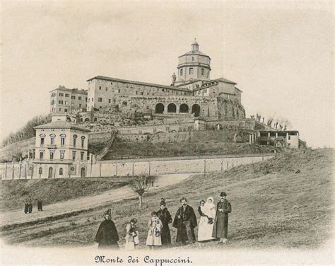 An Old Black And White Photo Of People Standing In Front Of A Castle