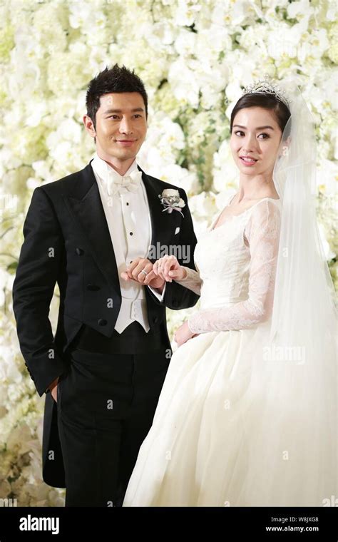 Chinese actor Huang Xiaoming, left, and his actress wife Angelababy ...