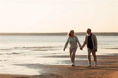 Free Photo | Couple holding hands at beach