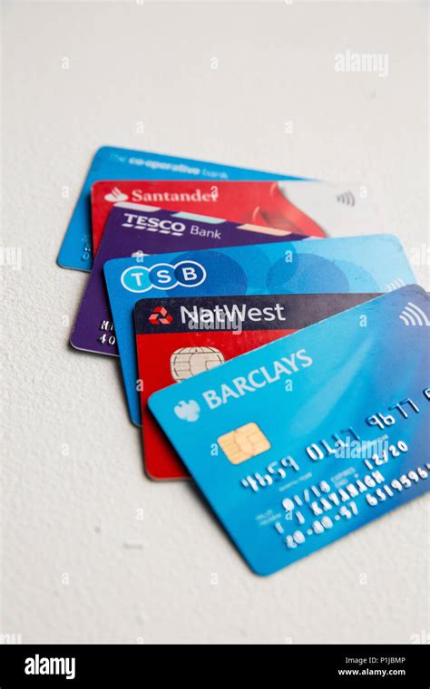 Five Visa Debit Cards In A Pile On A White Background Including Tesco