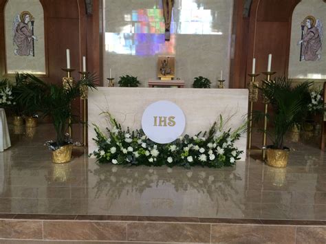 The Altar Is Decorated With Flowers And Greenery