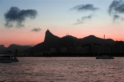 Premium Photo | A sunset over rio with the rio de janeiro skyline in ...