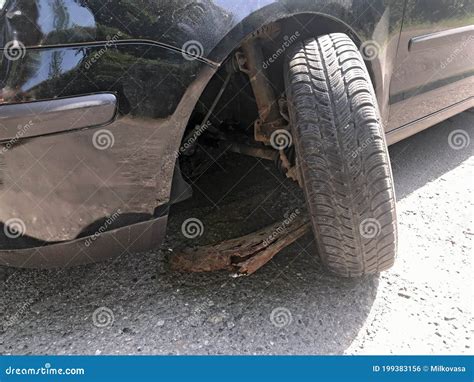 Damaged Wheel Of A Car Caused By Hole In A Rural Road Stock Photo