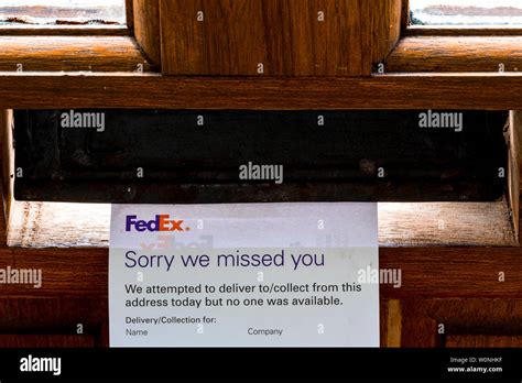 FedEx 'sorry we missed you" card left in letterbox Stock Photo - Alamy