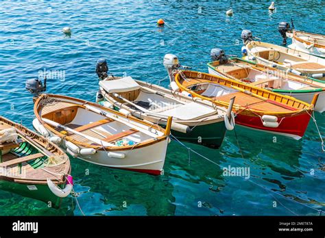 Colourful Fishing Boats Reflected In The Water In The Harbour Of