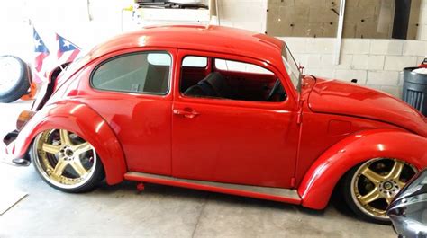 An Old Red Car Parked In A Garage