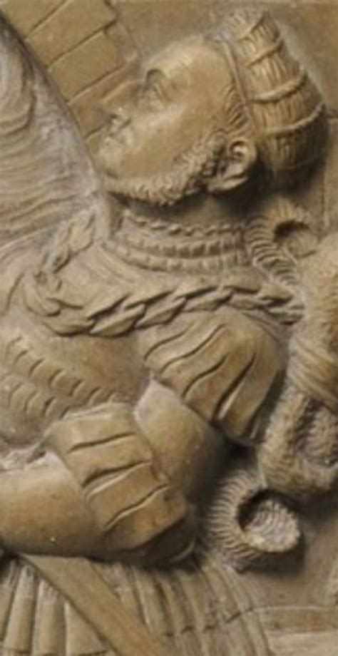 An Ancient Carving Of A Man Holding A Bird