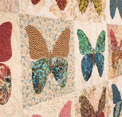 A Close Up Of A Quilt With Butterflies On It