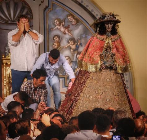 Two Men Standing On Top Of A Stage Surrounded By People In Front Of A