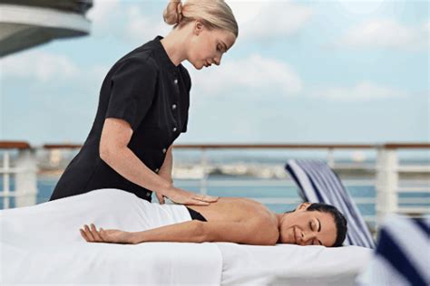 A Woman Getting A Back Massage On The Deck Of A Cruise Ship While Another Woman Watches