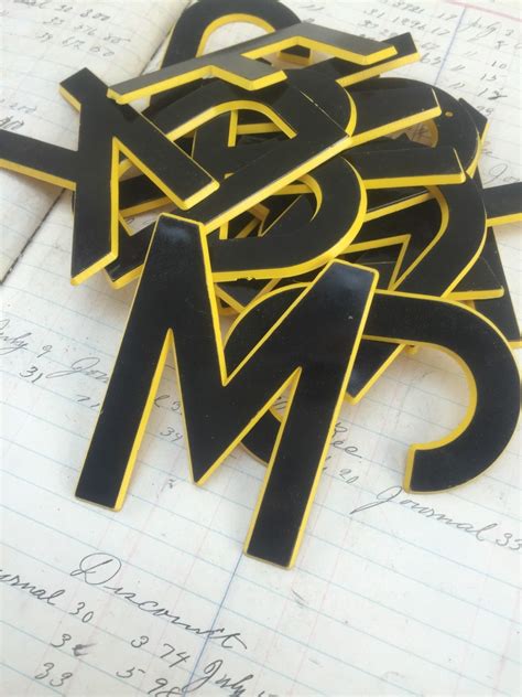 Vintage plastic sign letter letters black and yellow letters