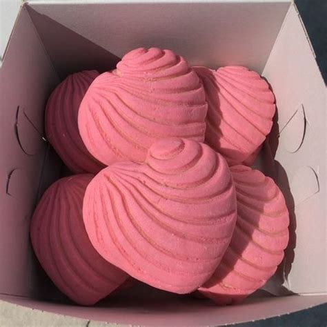 Three Pink Macaroons In A Box On The Ground