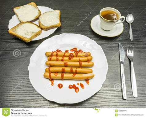 A Plate Of Boiled Sausages With Ketchup Sandwiches With Dark Brown