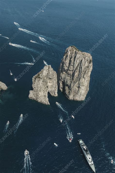 Aerial View Of Boats Sailing Near Capri S Faraglioni Italy Stock