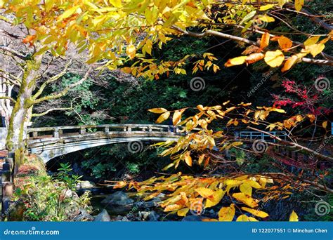 Beautiful Scenery Of A Stone Arch Bridge Over A Stream Surrounded By