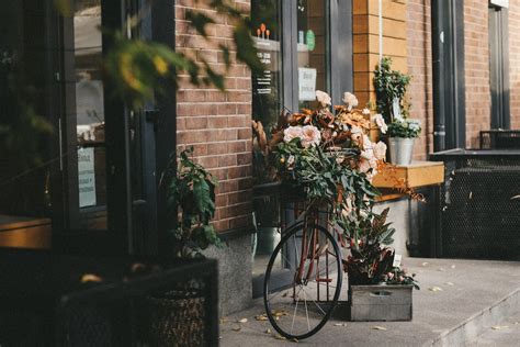 A Shot of Bike Next to a Flower Shop · Free Stock Photo