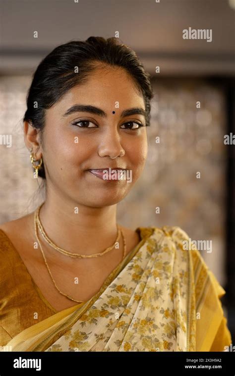 Indian Young Woman Wearing Traditional Saree Smiling At Camera At Home