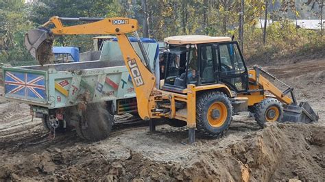 Jcb Backhoe Collecting Soil And Loading In Dump Truck Tractor