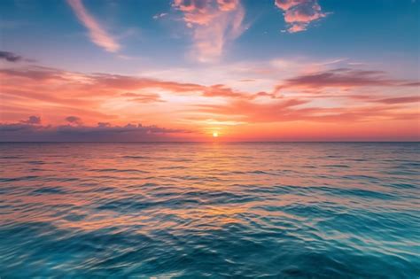 Premium AI Image | A sunset over the ocean with a blue sky and clouds