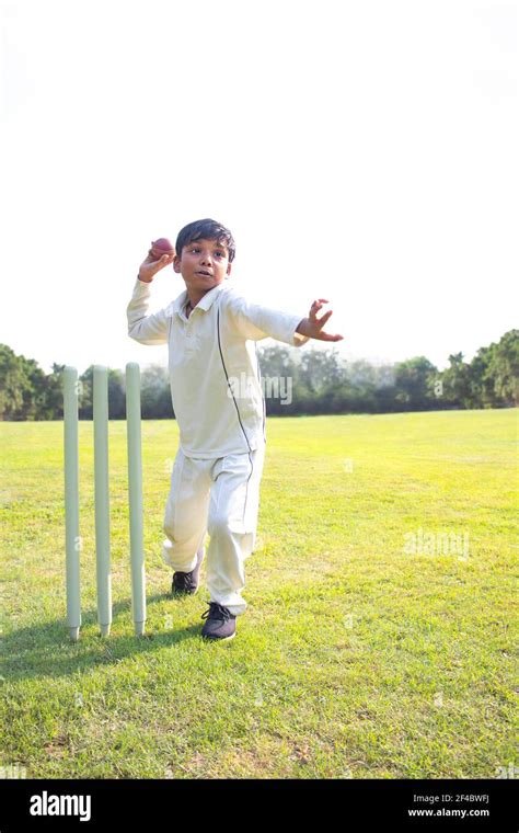 Young boy bowling leg spin in a cricket Stock Photo - Alamy