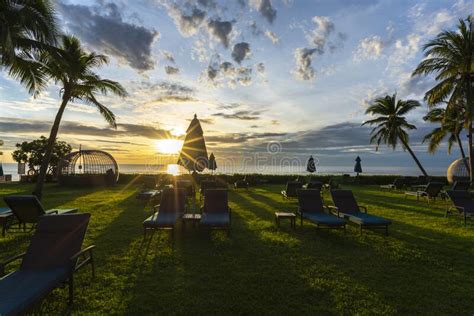 Beautiful Sunrise View Of Tropical Beach With Lounge Chairs And