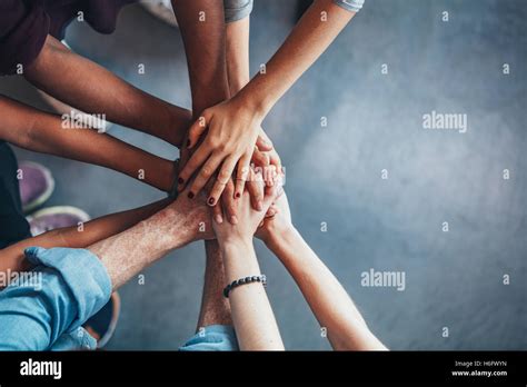 Close Up Top View Of Young People Putting Their Hands Together Friends