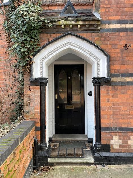 Premium Photo | Black front door of a beautiful brick house in england