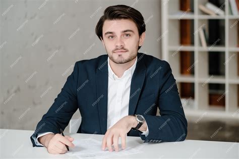 Premium Photo | Handsome man in a suit working in the office