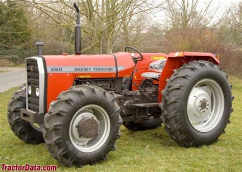 an orange tractor parked on top of a lush green field