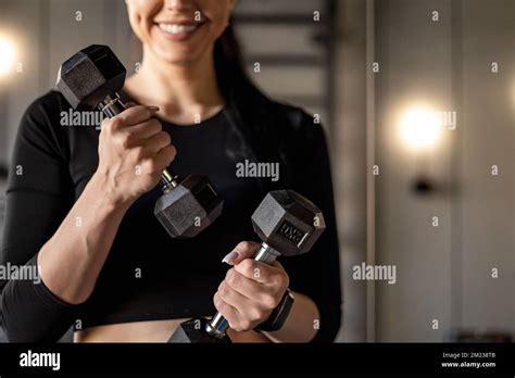 Portrait Happy Athletic Brunette Woman Posing At Mirror Holding Dumbbells Smiling Healthy