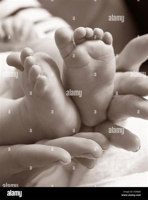 Small Baby Legs In Mother Hands Stock Photo Alamy